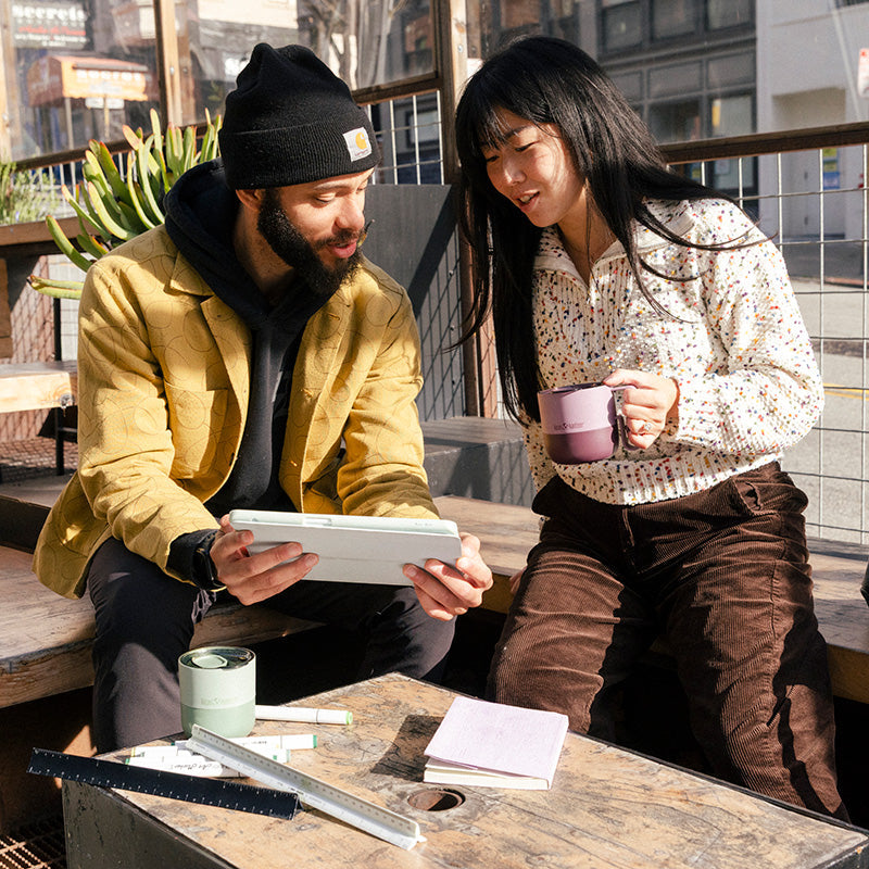 12oz-rise-mug-v5 12oz_rise_coffee_mug_dusty_orchid_couple_city_patio_square.jpg