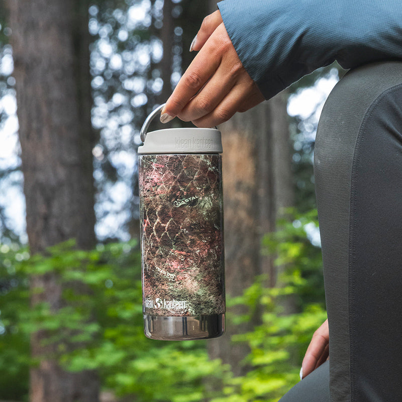 12oz-tkwide-with-twist-cap-mossy-oak-o8 12oz_tumbler_mossyoak_rainbowtrout_hand_closeup_square.jpg