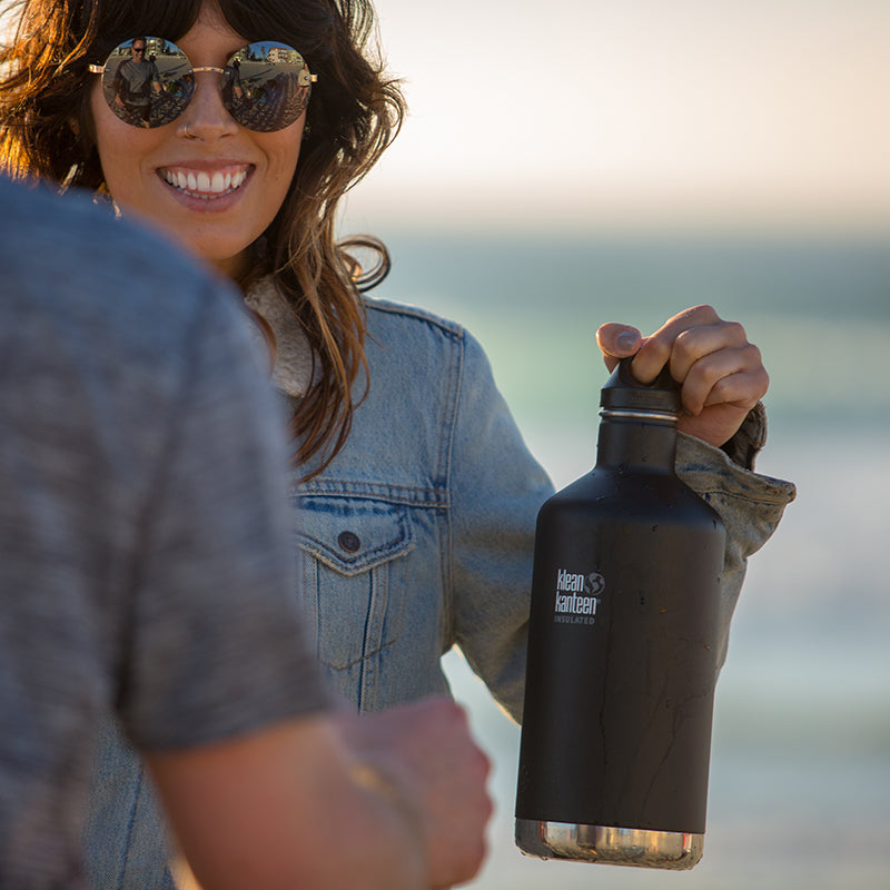 64oz-classic-with-loop-cap-m2 64oz_insulated_classic_black_beach_girl_hand_square.jpg